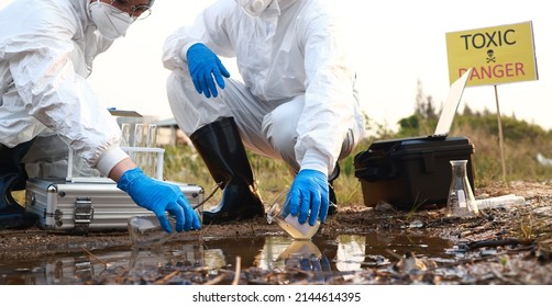 Scientist or Biologist in a protective suit and mask, collects sample of waste water from industrial. Environment Issue concept - Shutterstock ID 2144614395