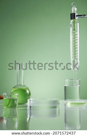 Scientist with chemical reaction in chemistry laboratory. close up of scientist making research in lab in green background , green water in test tube and blank space for advertising , front view
