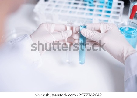 Scientist compare difference between two test tubes laboratory science research chemistry chemical liquid medical research experiment examining technician healthcare and medicine analyzing biology