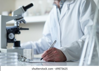 Scientist Conducting Research With Microscope Selective Focus