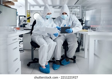 Scientist, Covid And Team Planning Research Document In Laboratory Medical Safety And Protection Corona Virus Results. Man And Woman Healthcare Science Doctors In Covid 19 Tech Paperwork Partnership