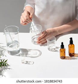The scientist, dermatologist testing the organic natural cosmetic product in the laboratory. Vials, glass laboratory flasks. Beauty cosmetic research and development concept.