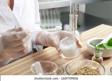 Scientist developing cosmetic product in laboratory, closeup