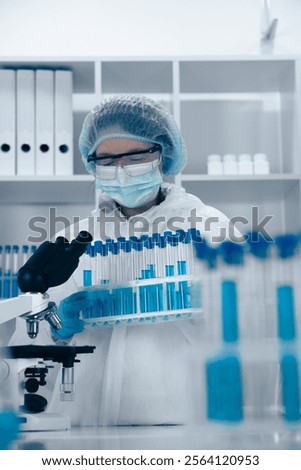 A scientist is diligently analyzing various samples in a cuttingedge, hightech laboratory environment that is equipped with modern tools and technology to advance scientific research and innovation