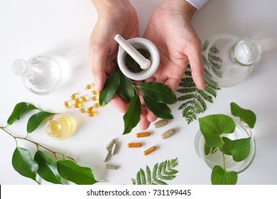 The Scientist Or Doctor Make Herbal Medicine From Herb In The Laboratory On The Table .alternative Treatment. Show Hand And Stethoscope. With The Bottle Container.