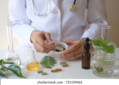 The Scientist Or Doctor Make Herbal Medicine From Herb In The Laboratory On The Table .alternative Treatment. Show Hand And Stethoscope. With The Bottle Container.