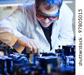 scientist doing research in a quantum optics  lab (shallow DOF; color toned image)