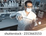 Scientist doing a test in a laboratory muffle in which a sample is calcined in a ceramic crucible. Selective focus