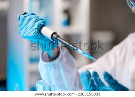 Scientist dropping a sample into a Petri dish