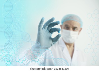 scientist, an elderly man in a white coat and a protective mask holds a DNA capsule, the concept of scientific molecular biotechnology, the study of genetics, close-up