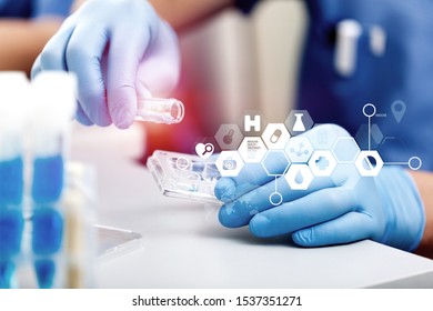 Scientist with equipment and science experiments ,laboratory glassware containing chemical liquid for design or decorate your content,copy space.Pipette dropping a sample into a test tube - Shutterstock ID 1537351271