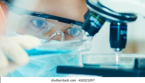 scientist with equipment and science experiments ,laboratory glassware containing chemical liquid for design or decorate science or other your content and selective focus