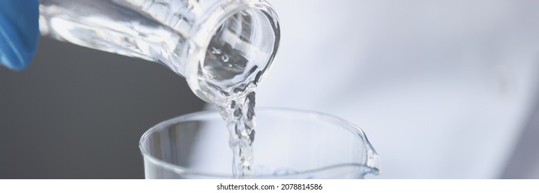 Scientist examines drinking water in laboratory. Presence of nitrates in water exceeding norm concept - Powered by Shutterstock