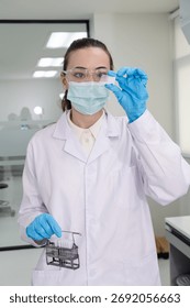 Scientist examining sample with test tubes in laboratory setting for research and analysis