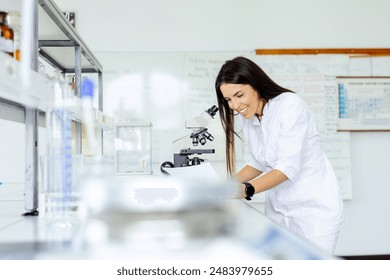 Scientist examining sample under microscope in lab