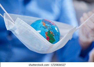 Scientist Holding Globe In Protective Mask