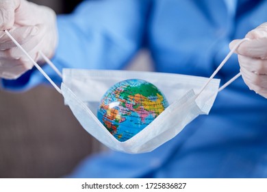 Scientist Holding Globe In Protective Mask