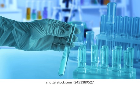 Scientist holding test tube in laboratory, closeup - Powered by Shutterstock