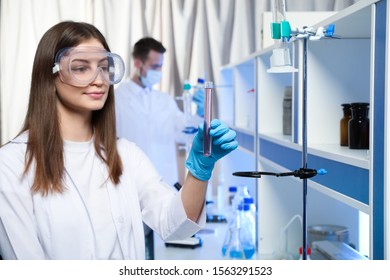 Scientist holding test tube with liquid indoors. Laboratory analysis