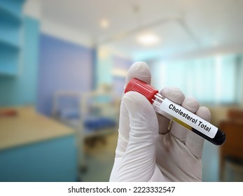 Scientist Holds Blood Sample For Cholesterol Total And Ldl Cholesterol Test With Patient Bed Background.