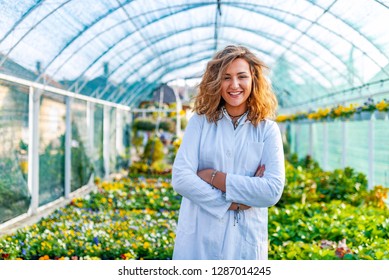 Scientist inspecting plants. Woman agronomist in greenhouse. Portrait of a Young Female Working in the Garden Center. Woman scientist.  - Powered by Shutterstock