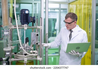 Scientist In Lab Coat, Researcher Working In Laboratory With Cannabis Oil CBD Extraction Machine, Chemical Lab Test On Cannabis Oil, CBD, THC, Alternative Medical. Extract Chemicals From Cannabis.