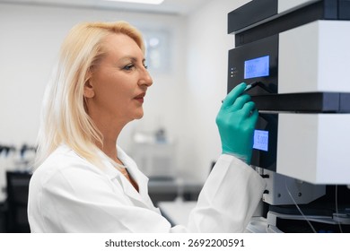 Scientist in lab coat using high-performance liquid chromatography instrument for precise analytical chemistry research.