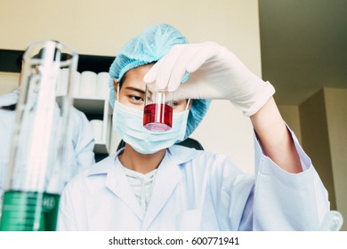 scientist in the laboratory working at lab with test tubes 