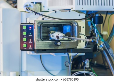 Scientist In A Laboratory Works With An Electron Microscope Gateway. Putting A Sample Into A Chamber.