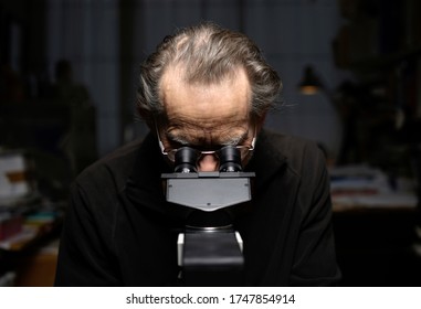 Scientist Looking Into Micro Scope In Labratory