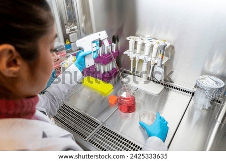 Scientist looking at sample into micropipette for biology hospital test. Biology doctor discovery scientifc experiment with technology equipment industry