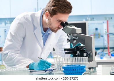 Scientist looking through a microscope in a laboratory