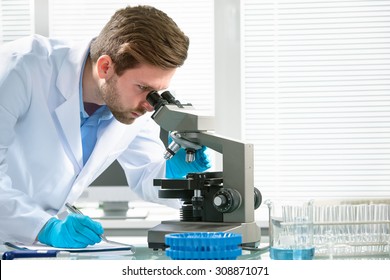 Scientist looking through a microscope in a laboratory