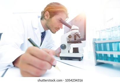 scientist makes a note of experiment in the laboratory