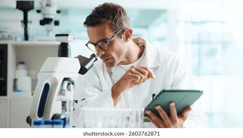 Scientist, man and tablet by microscope in lab for medical research with container, review or vaccine development. Person, digital touchscreen and chemical analysis with pharmaceutical drugs on app