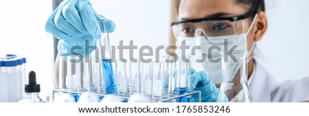 Scientist or medical in lab working in biotechnological laboratory using equipment for research with mixing reagents in glass flask in clinical laboratory.