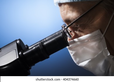 Scientist With Microscope In Chemical Laboratory