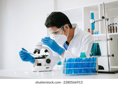 Scientist mixing chemical liquids in the chemistry lab. Researcher working in the chemical laboratory

 - Powered by Shutterstock