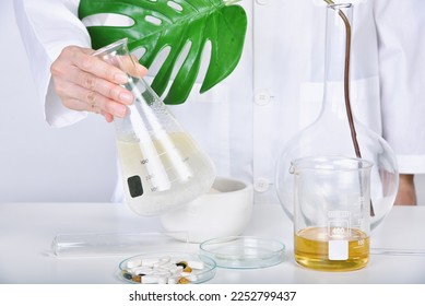 Scientist mixing drug ingredient, Alternative herbal medicine, Natural organic botany and scientific glassware, Natural skin care beauty products research. - Powered by Shutterstock