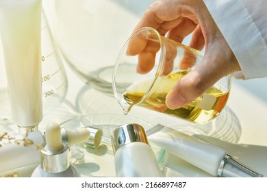 Scientist mixing natural skin care beauty products, Organic botany extraction and scientific laboratory glassware, Blank label cosmetic container for branding mock-up. - Shutterstock ID 2166897487