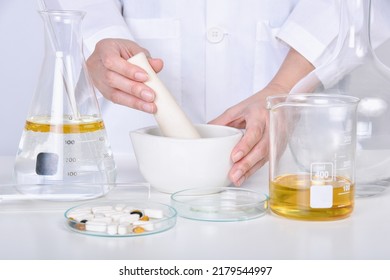 Scientist mixing vitamin supplement, Pills and scientific laboratory glassware, Medicine research and development concept, Pharmaceutical quality control test. - Powered by Shutterstock