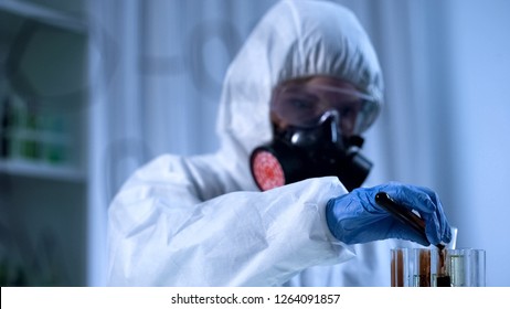 Scientist pouring mineral oil into test tube, production from petroleum products - Powered by Shutterstock