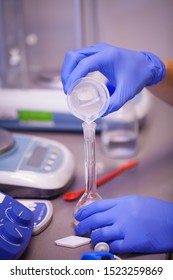 Scientist preparing a chemical solution for analysis using accurate laboratory equipment