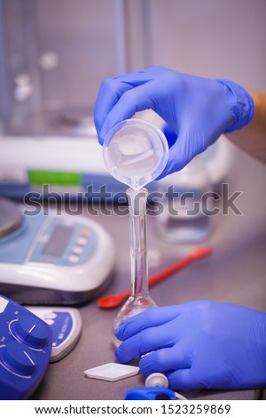 Scientist preparing a chemical solution for analysis using accurate laboratory equipment