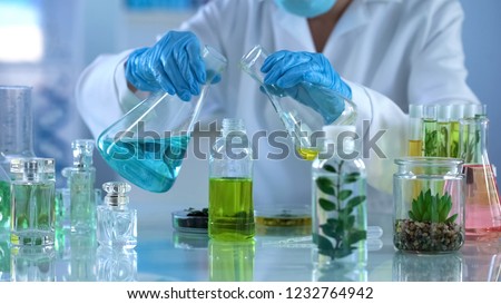 Scientist preparing liquid for experiments, testing new mixture for aromatherapy