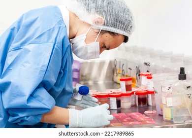 Scientist processing biopsy samples at the pathology laboratory to be embedded in paraffin for analysis. Cancer diagnosis concept. Medical concept.