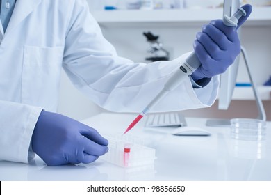 Scientist processing DNA sample in laboratory selective focus