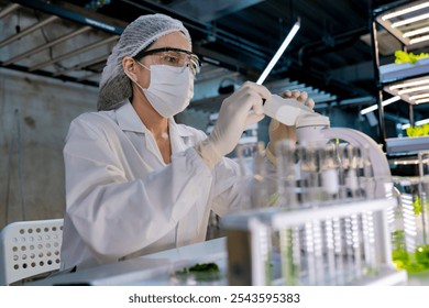 A scientist in protective gear, including a hairnet, mask, gloves, observes samples through a microscope in a high-tech lab. The setup emphasizes precision, research, and advanced scientific analysis. - Powered by Shutterstock