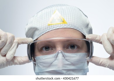 Scientist Putting On Protective Eyewear