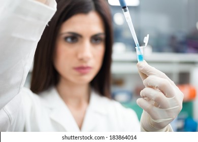 Scientist putting a sample in a test tube in a chemical laboratory - Powered by Shutterstock - Get 15% off with code: PIKWIZARD15